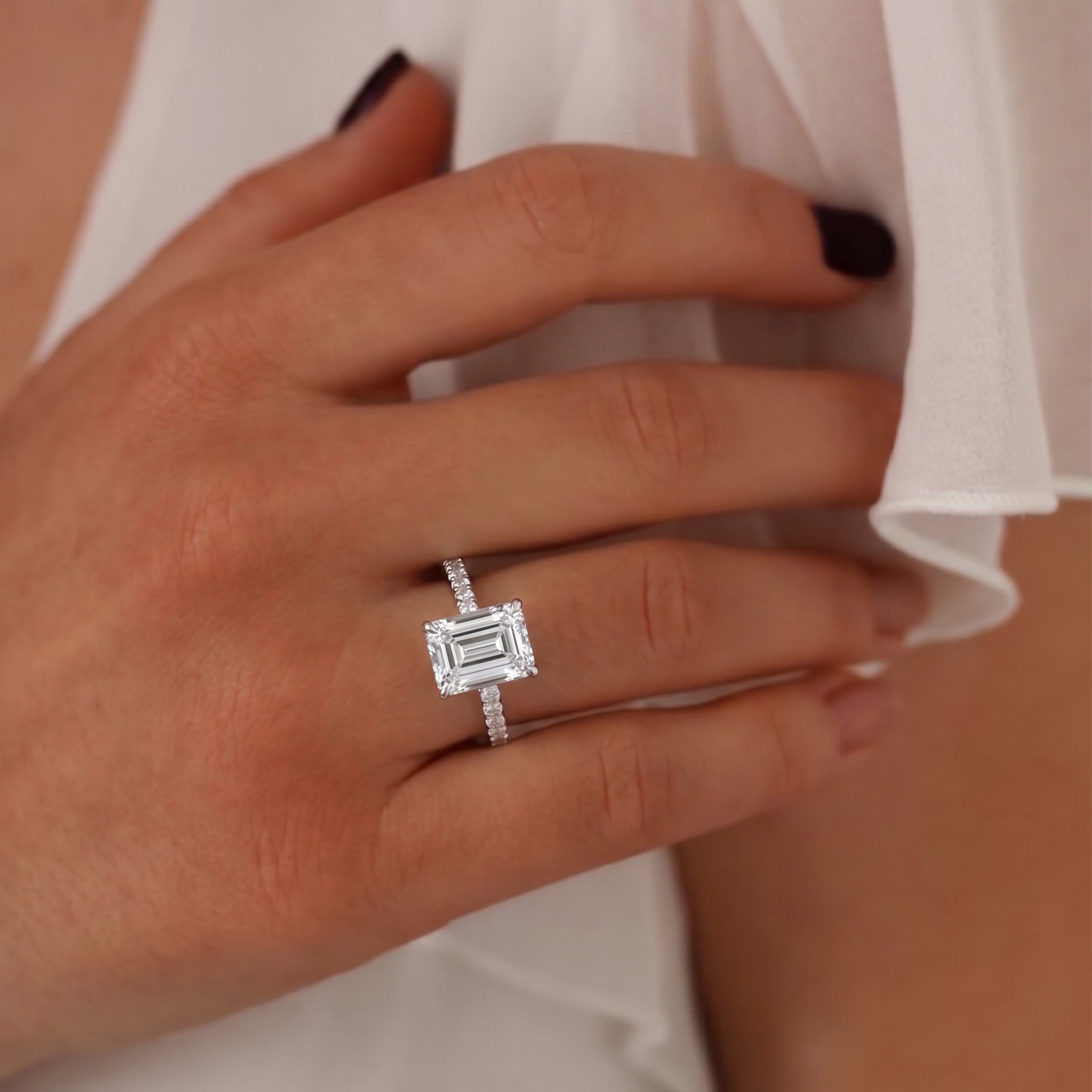 emerald cut hidden halo engagement ring in white gold