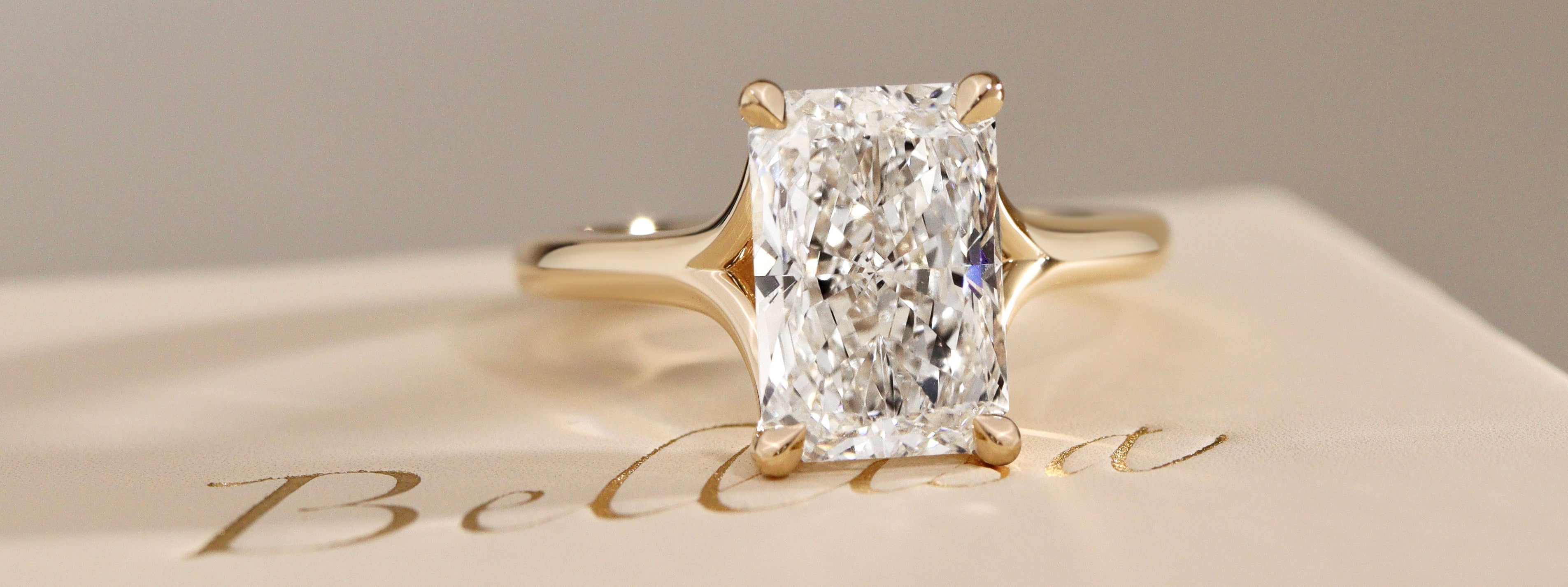 radiant cut diamond split shank solitaire engagement ring in yellow gold