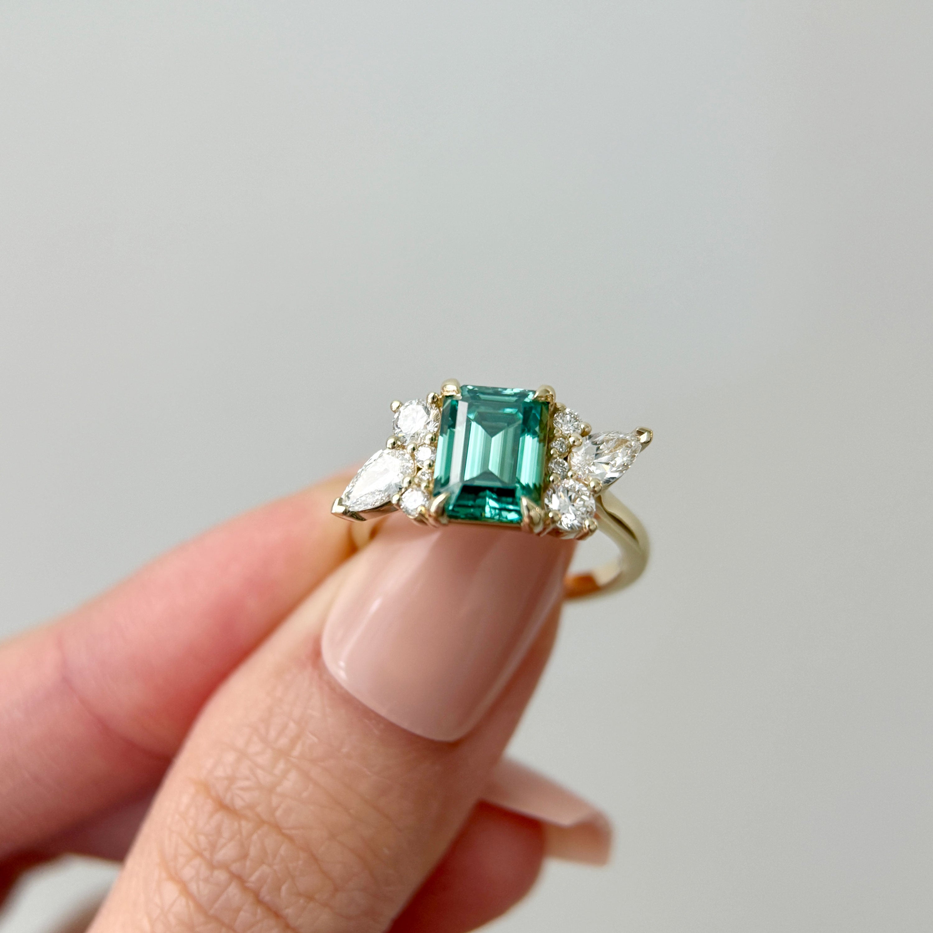 Meghan Emerald Cut Asymmetric Cluster Engagement Ring