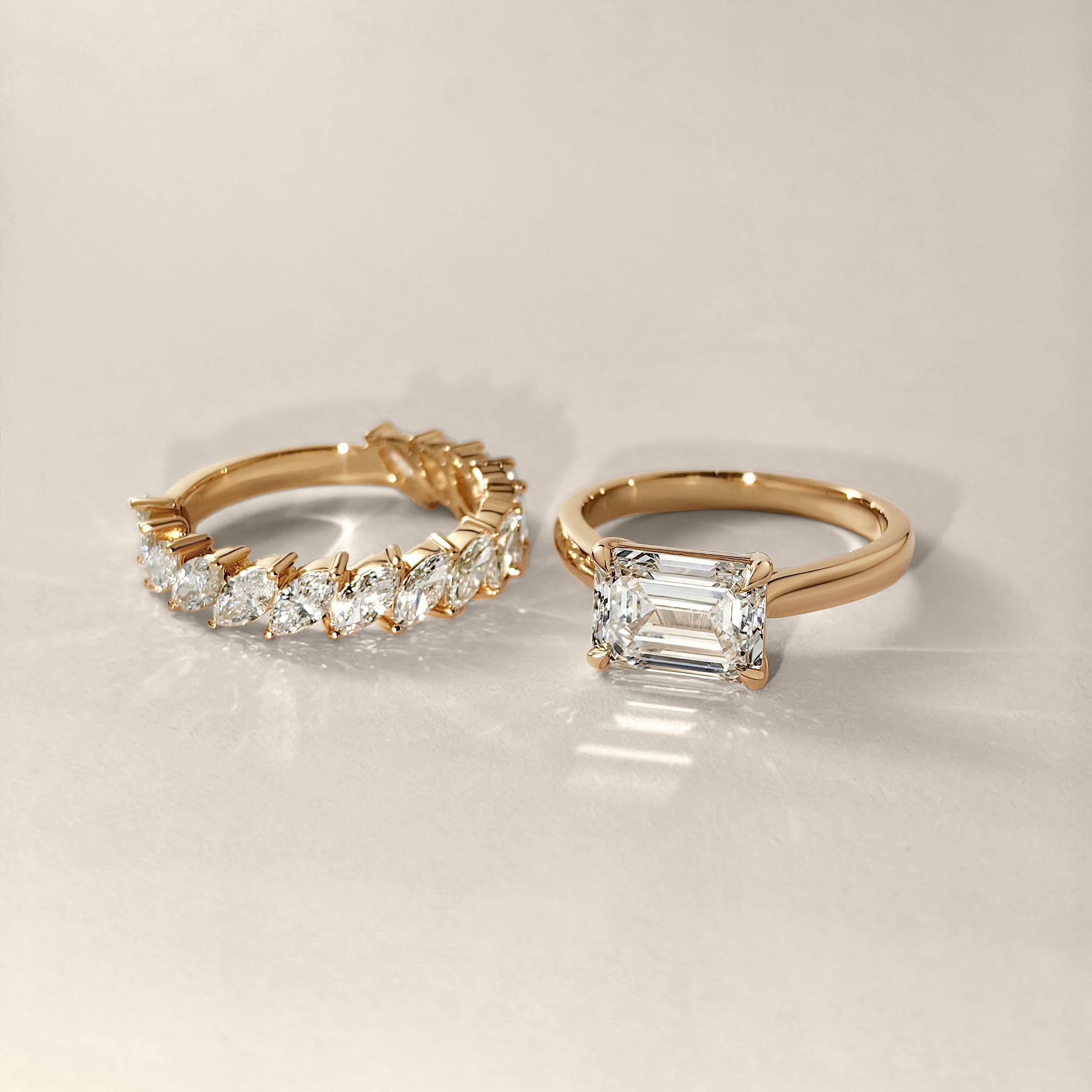 slanted marquise diamond band with east west emerald diamond solitaire ring