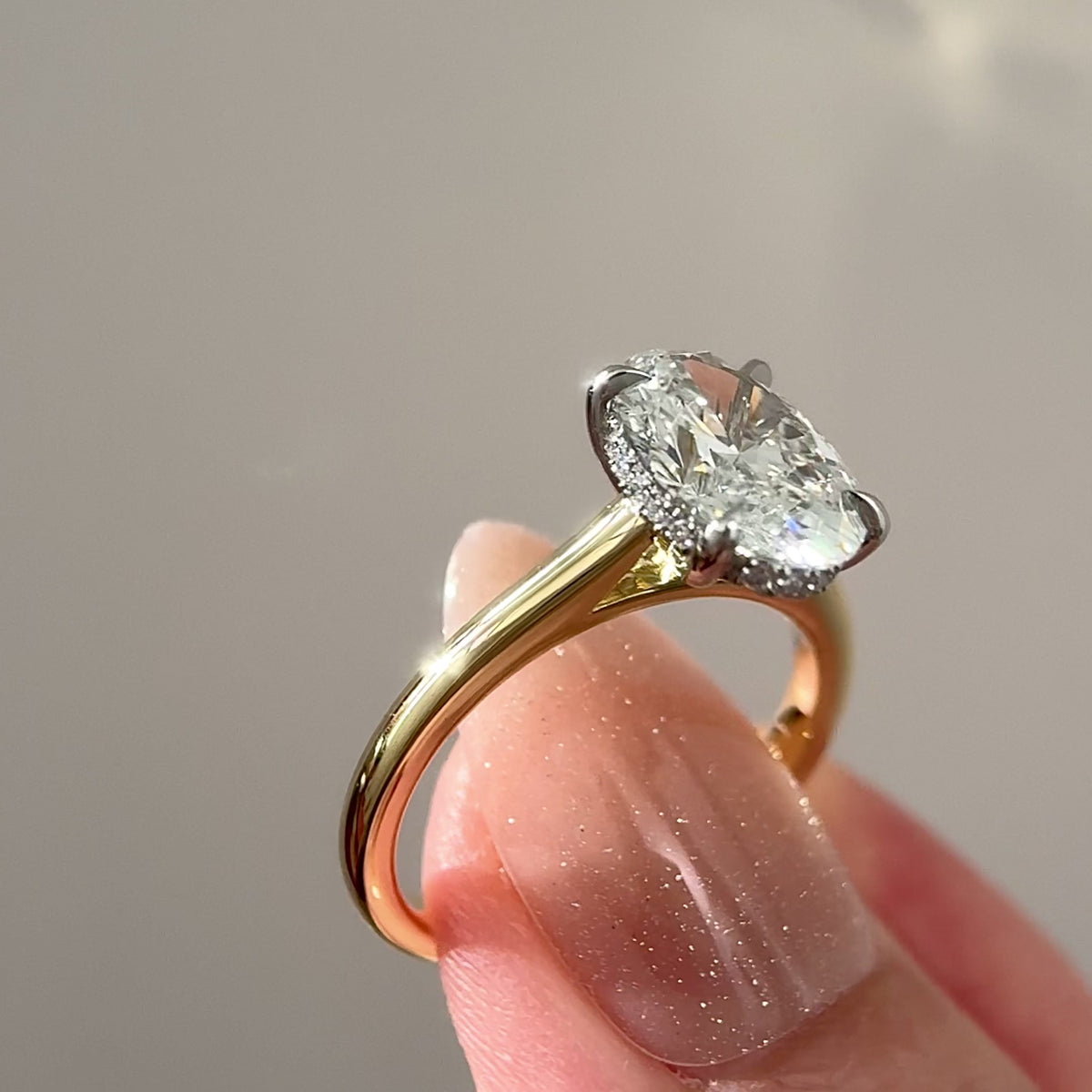 two-tone-oval-hidden-halo-engagement-ring