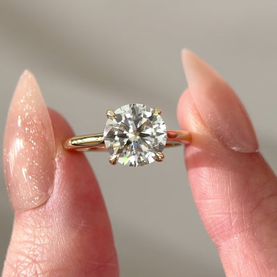 round moissanite hidden halo engagement ring in cathedral setting