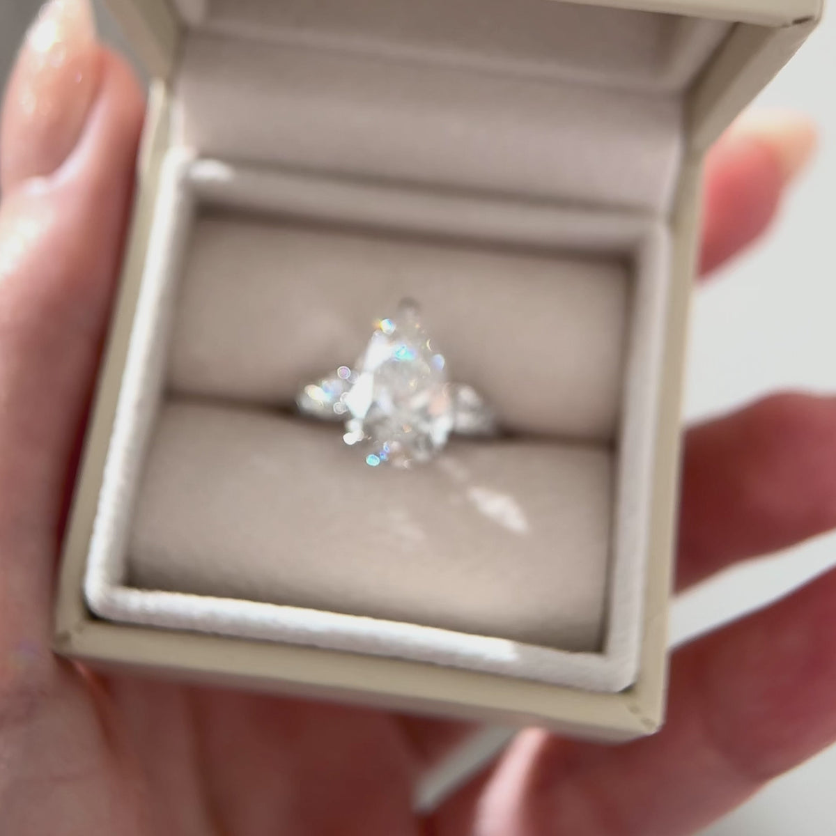 Pear cut three stone engagement ring