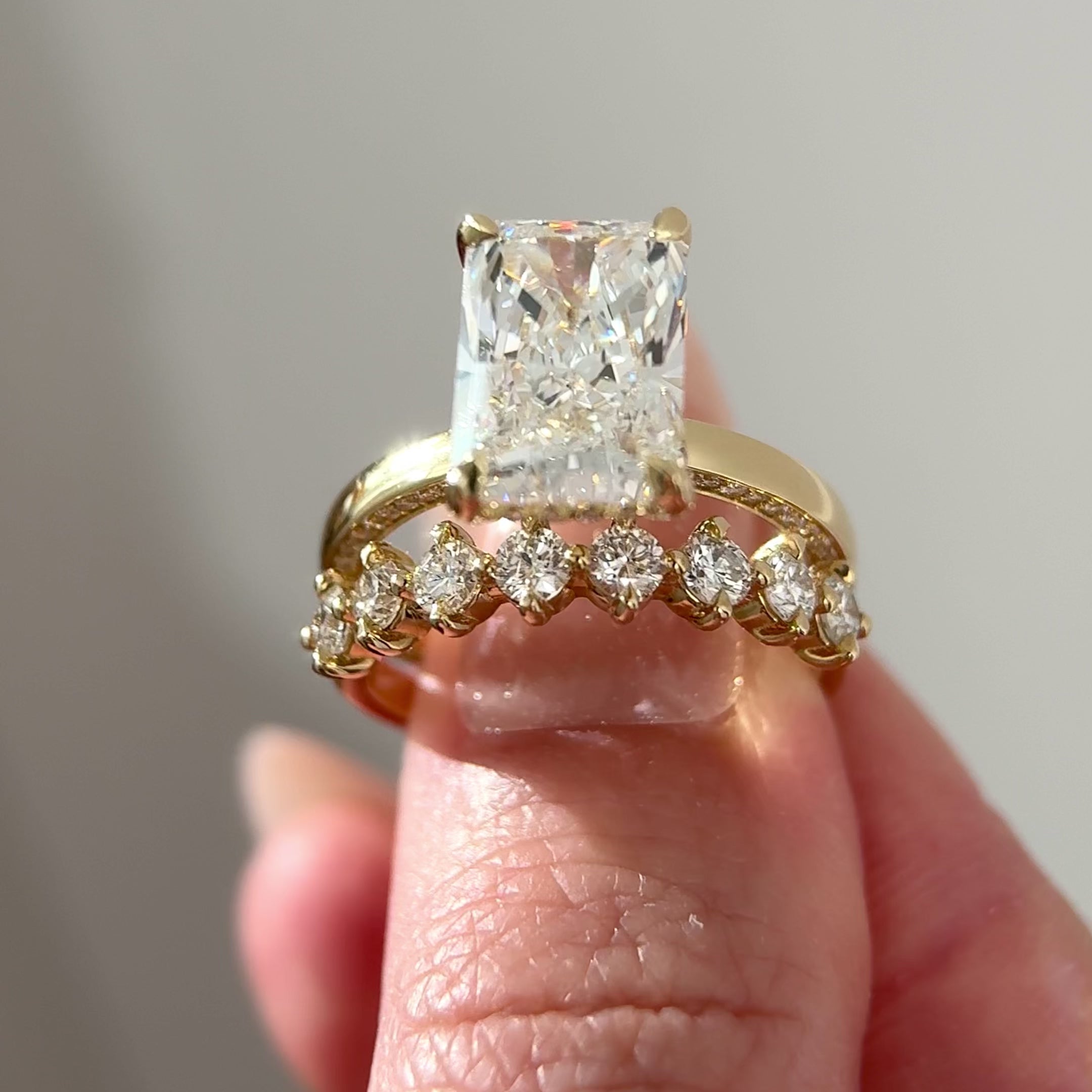 radiant cut diamond side pave engagement ring with round diamond bubble band