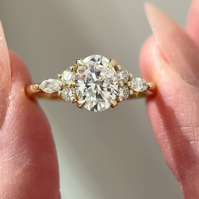 oval cut moissanite cluster engagement ring in yellow gold