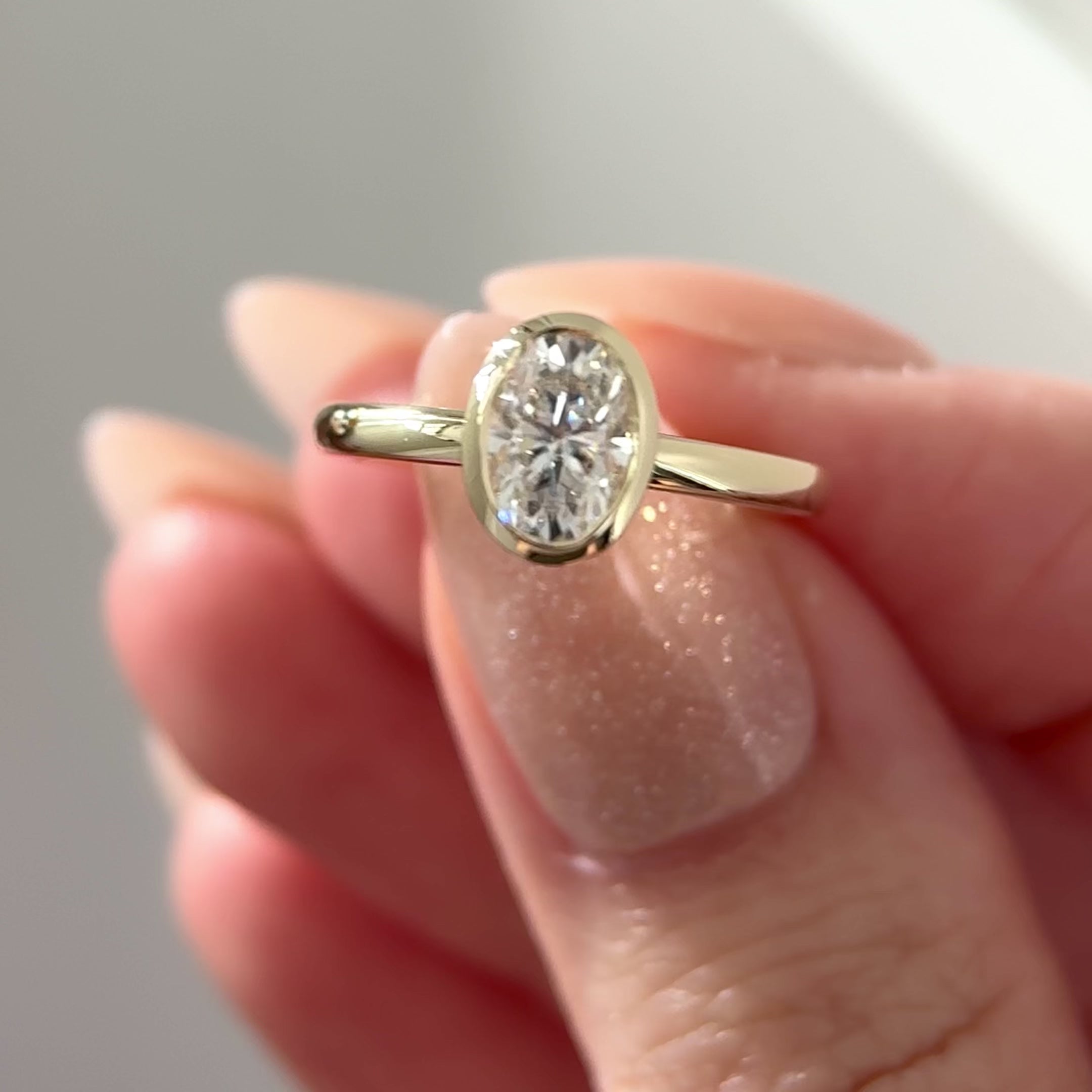 oval moissanite bezel ring with petal gallery