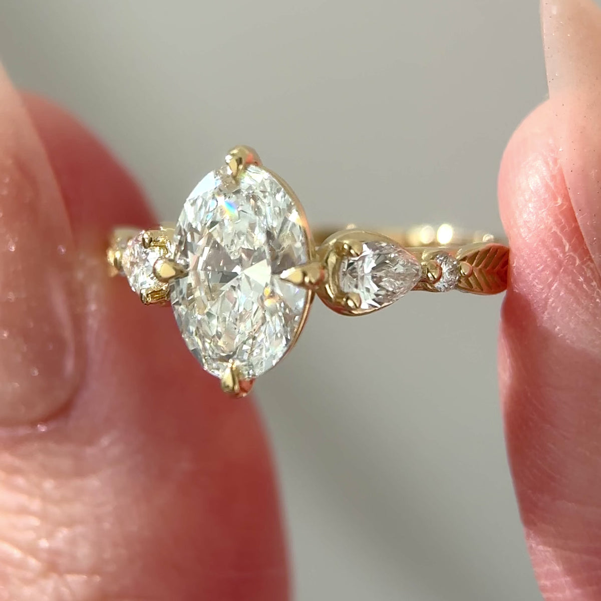 oval engagement ring with leaf inspired diamond band