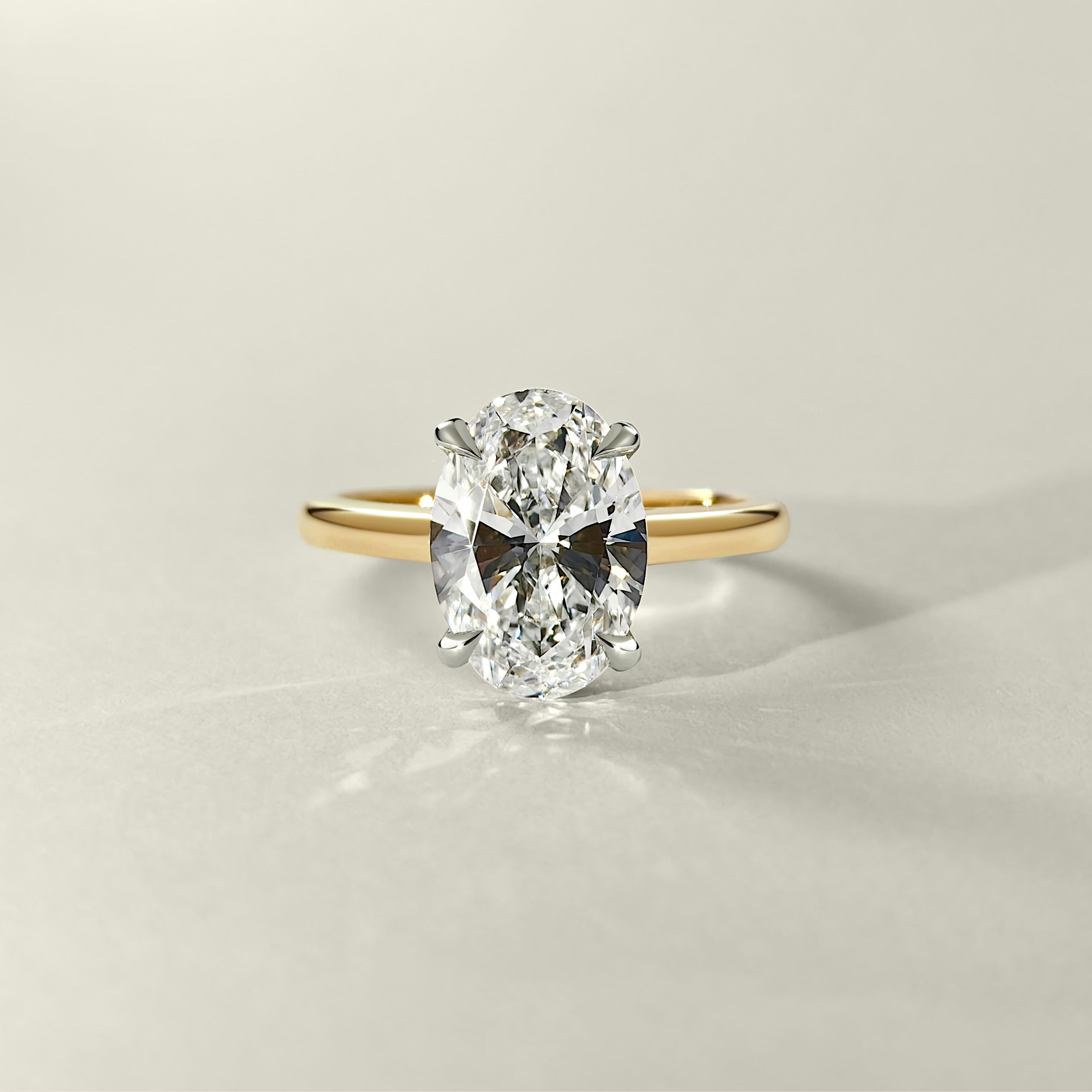 two-tone-oval-hidden-halo-engagement-ring 